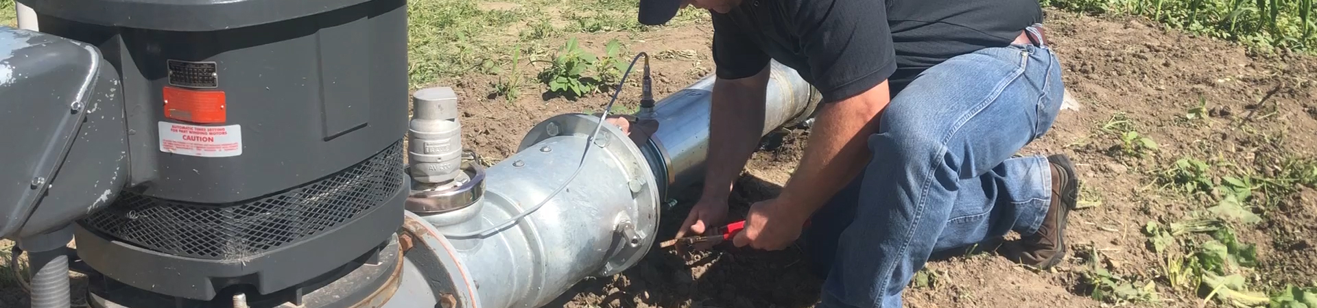 Man working on irrigation pump
